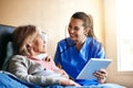 According to the records, youre doing way better. a nurse examining a senior patient with a stethoscope.