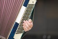 Accordion in the hands of a musician, close-up view. Royalty Free Stock Photo