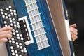 Accordion in the hands of a musician, close-up view. Royalty Free Stock Photo