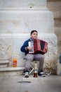 Accordion player, poor child busker