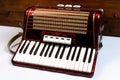 Accordion on a white and wooden background