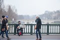 Accordionist plating accordion on the Arcole bridge in Paris, over the Seine river