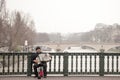 Accordionist plating accordion on the Arcole bridge in Paris, over the Seine river.