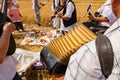 Accordionist stretches bellow of harmonic, music for good harvest