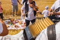 Accordionist stretches bellow of harmonic, music for good harvest