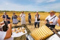 Accordionist stretches bellow of harmonic, music for good harvest