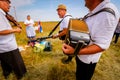 Accordionist stretches bellow of harmonic, music for good harvest