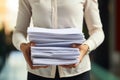 An accountant carries a stack of documents in his hands. A female secretary holds a stack of papers in her hands. Concept: Office