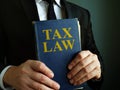 Accountant holds tax law book