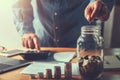 accountant saving money hand holding coins putting in jug glass. concept finance Royalty Free Stock Photo