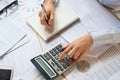 accountant working on desk to using calculator with pen on book Royalty Free Stock Photo