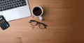 Accountant workplace with calculator, notebook, glasses, coffee cup, laptop and pen on wooden desk. Royalty Free Stock Photo