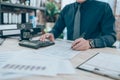 Accountant writing, checking and working on company data, document, report and calculator to calculate  on desk office. Accounting Royalty Free Stock Photo