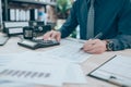 Accountant writing, checking and working on company data, document, report and calculator to calculate  on desk office. Accounting Royalty Free Stock Photo