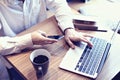 Accounting business man use laptop computer and mobile phone in cafe, writing business plan, drinking coffee coffee. Royalty Free Stock Photo