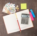 Accounting and business management Banknotes, calculator and Euro banknotes on wooden background. Tax, debit and costing. Royalty Free Stock Photo