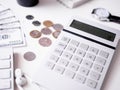 Accounting concept with keyboard, smartphone, notebook, coffee cup, calculator and money on white table background. Royalty Free Stock Photo