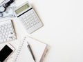 Accounting concept with keyboard, smartphone, notebook, coffee cup, calculator and money on white table background. Royalty Free Stock Photo