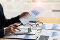 At the accounting desk, an accountant presses a calculator to analyze investment charts to generate monthly financial reports or c Royalty Free Stock Photo