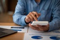 At the accounting desk, an accountant presses a calculator to analyze investment charts to generate monthly financial reports or c Royalty Free Stock Photo