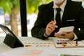 At the accounting desk, an accountant presses a calculator to analyze investment charts to generate monthly financial reports or c Royalty Free Stock Photo