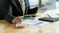 At the accounting desk, an accountant presses a calculator to analyze investment charts to generate monthly financial reports or c Royalty Free Stock Photo