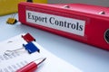Accounting documents and a folder labeled export controls. Financial regulation and sanctions. Royalty Free Stock Photo