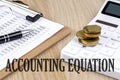 ACCOUNTING EQUATION text with chart and calculator and coins , business concept Royalty Free Stock Photo
