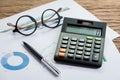 Accounting equipments, work corporate profit or finance calculations, savings concept with pen, calculator and eyeglasses on Royalty Free Stock Photo