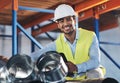 Accounting for everything. a handsome young contractor crouching down and doing a stock-take in the warehouse.