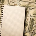 Accounting notebook for notes lying on money background Royalty Free Stock Photo