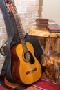 Accoustic guitar by the brick wall