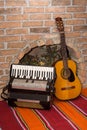 Accoustic guitar on the brick wall and accordion Royalty Free Stock Photo