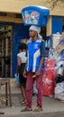 ACCRA,REPUBLIC OF GHANA - APRIL 30,2018:The young man sells ice cream. He holds the refrigerator with the goods on his head