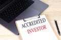 ACCREDITED INVESTOR text on clipboard on laptop