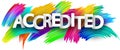 Accredited paper word sign with colorful spectrum paint brush strokes over white