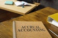 Accrual accounting guide near a folder on the table. Royalty Free Stock Photo