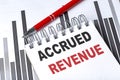 ACCRUED REVENUE text on notebook on chart with pen Royalty Free Stock Photo