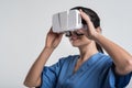 Merry female doctor adjusting VR glasses