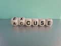 Accuse and excuse symbol. Turned cubes and changes the word accuse to excuse. Beautiful grey table blue background.