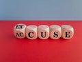 Accuse and excuse symbol. Turned cubes and changes the word accuse to excuse. Beautiful red table blue background.
