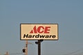 Ace Hardware advertisement sign that`s bright and colorful with blue sky on a metal pole in Kansas.