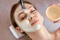 ace peeling mask, spa beauty treatment, skincare. Woman getting facial care by beautician at spa salon, close-up Royalty Free Stock Photo