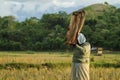 An old woman in a rice field separating grain in a traditional way Royalty Free Stock Photo