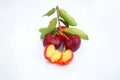 Acerola Cherry with half slice and green leaves isolated on white background Royalty Free Stock Photo