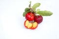 Acerola Cherry with half slice and green leaves isolated on white background Royalty Free Stock Photo