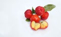 Acerola Cherry with half slice and green leaves isolated on white background Royalty Free Stock Photo