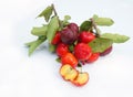 Acerola Cherry with half slice and green leaves isolated on white background Royalty Free Stock Photo