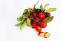 Acerola Cherry with half slice and green leaves isolated on white background Royalty Free Stock Photo