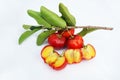 Acerola Cherry with half slice and green leaves isolated on white background Royalty Free Stock Photo